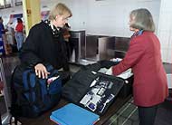 A traveler's baggage gets searched at Reagan National Airport